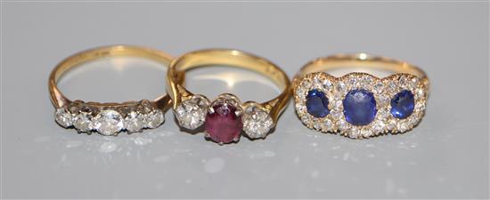 An 18ct, ruby and diamond three stone ring, an 18ct and five stone diamond ring and a yellow metal, sapphire & diamond ring.
